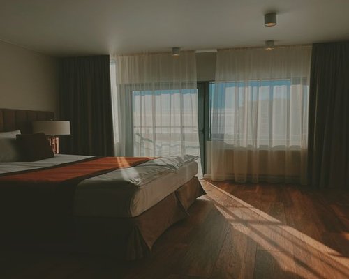 A serene cozy bedroom setting lit with warm sunlight, emphasizing proper rest environments